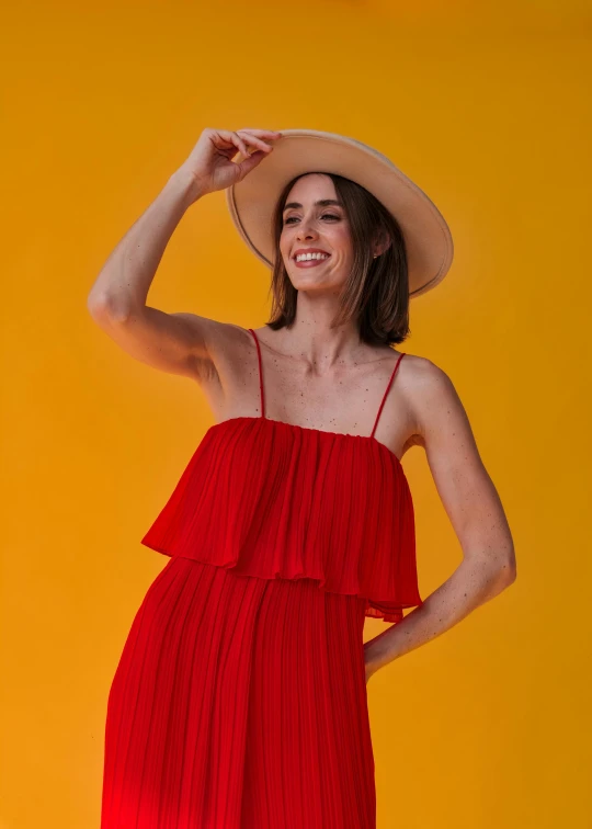 a beautiful woman posing with her hat in hand