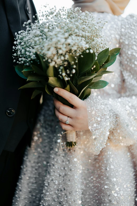 there is a woman holding white flowers