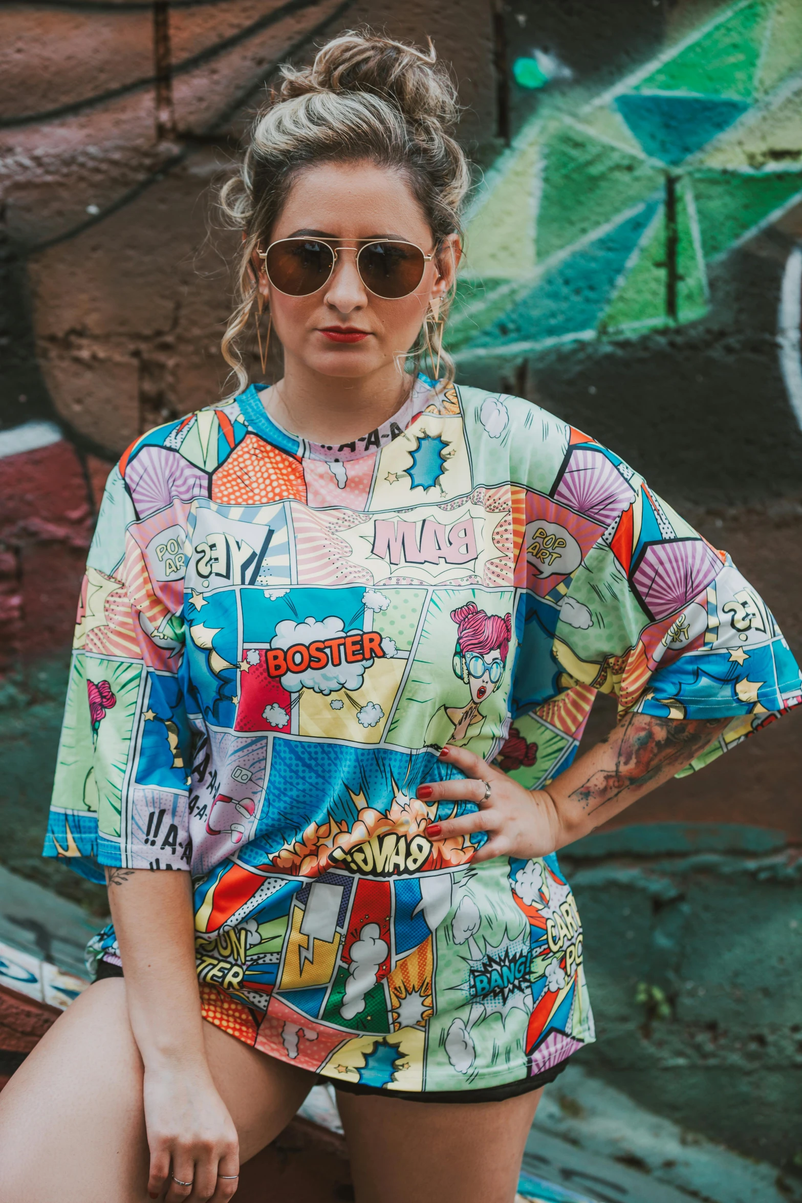 a woman wearing sunglasses and an unoned shirt