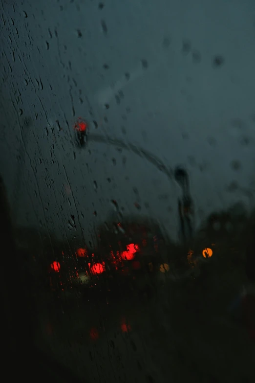 the view of an urban street through rain drops