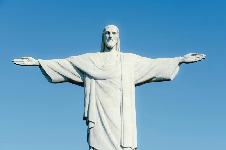 the statue of christ stands high in the sky