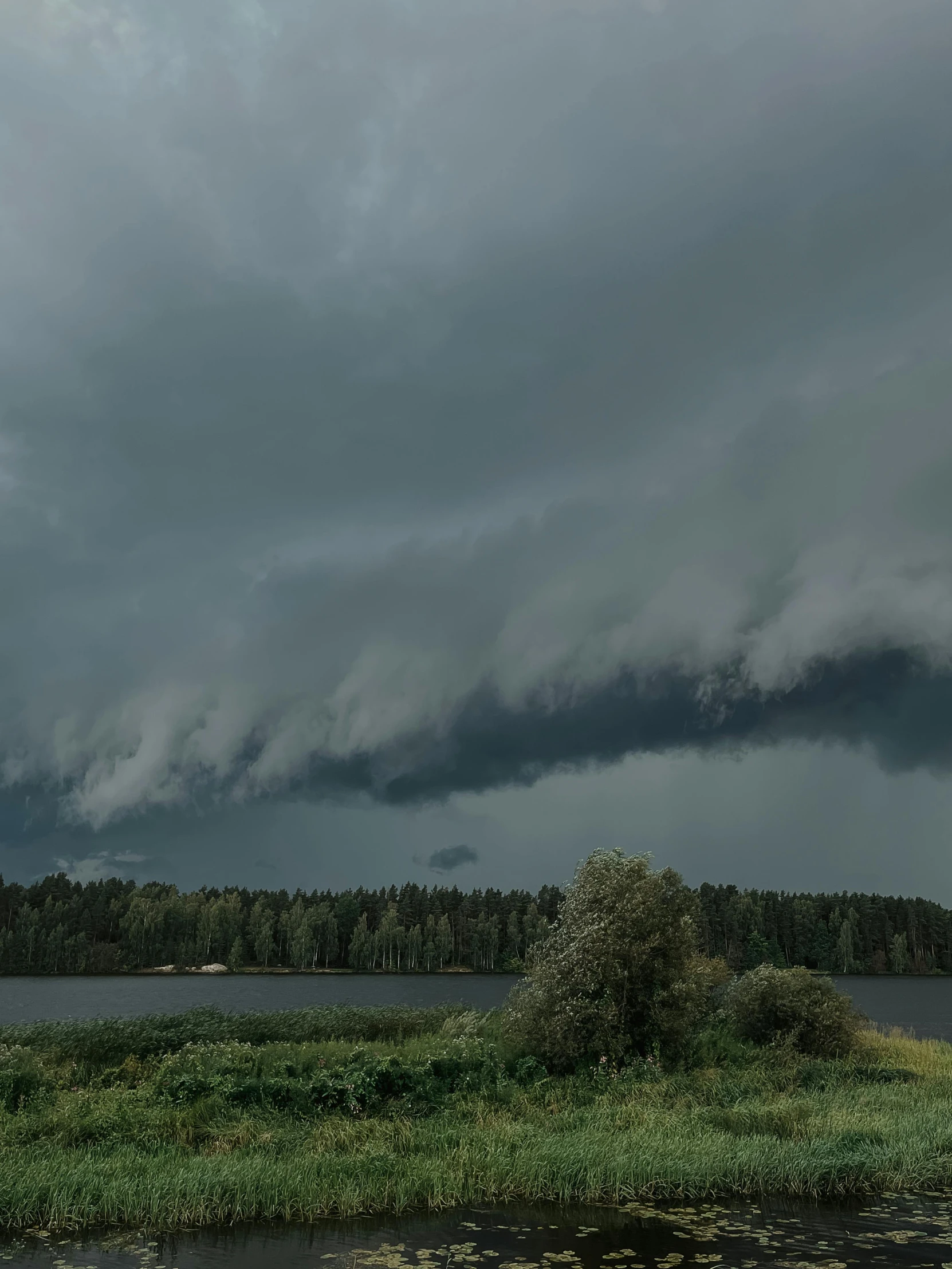 a body of water with many clouds above it