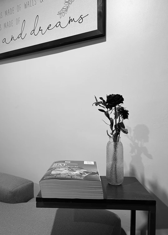 a vase of flowers on a table near a wall