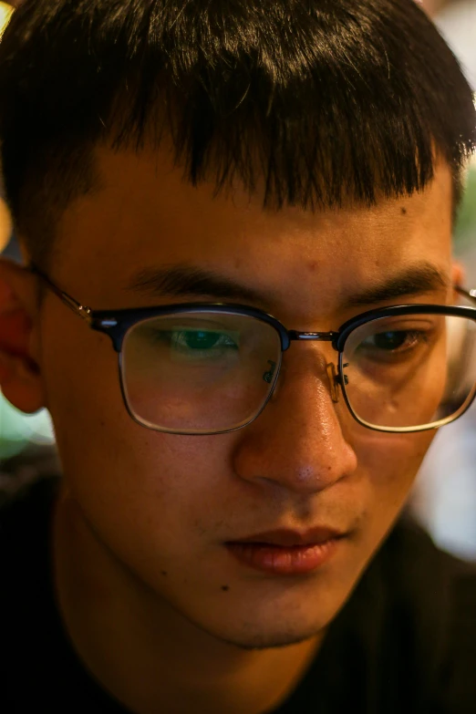 a close up of a person with glasses looking off into the distance