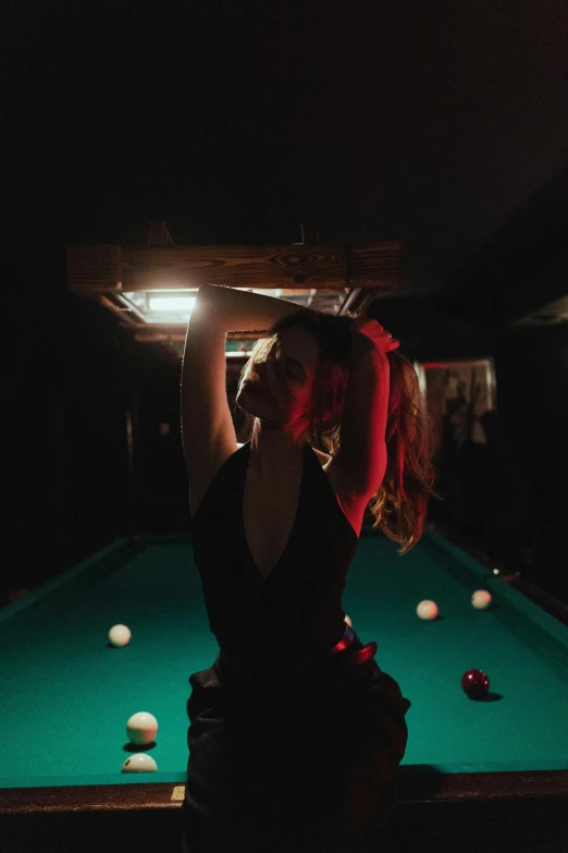 a person is standing next to a pool table