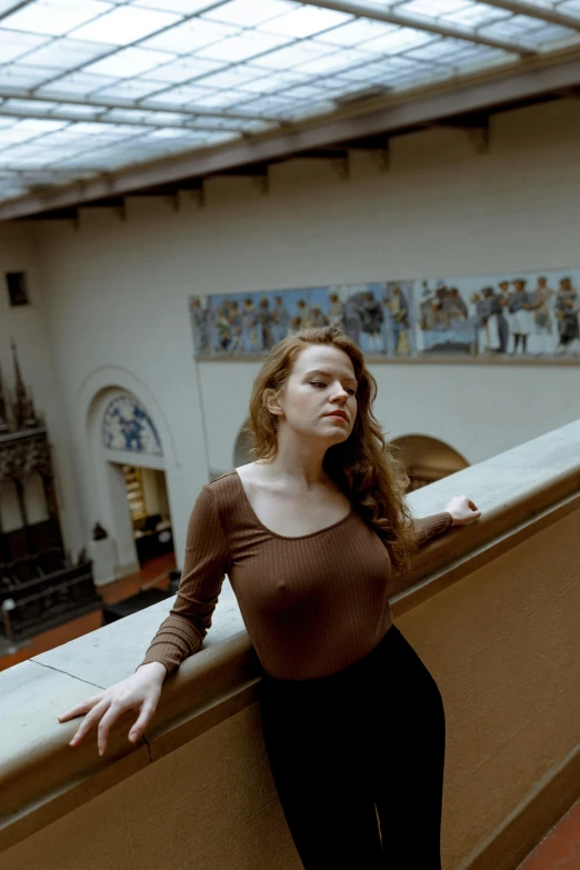 a woman leaning on the wall, leaning against a wall