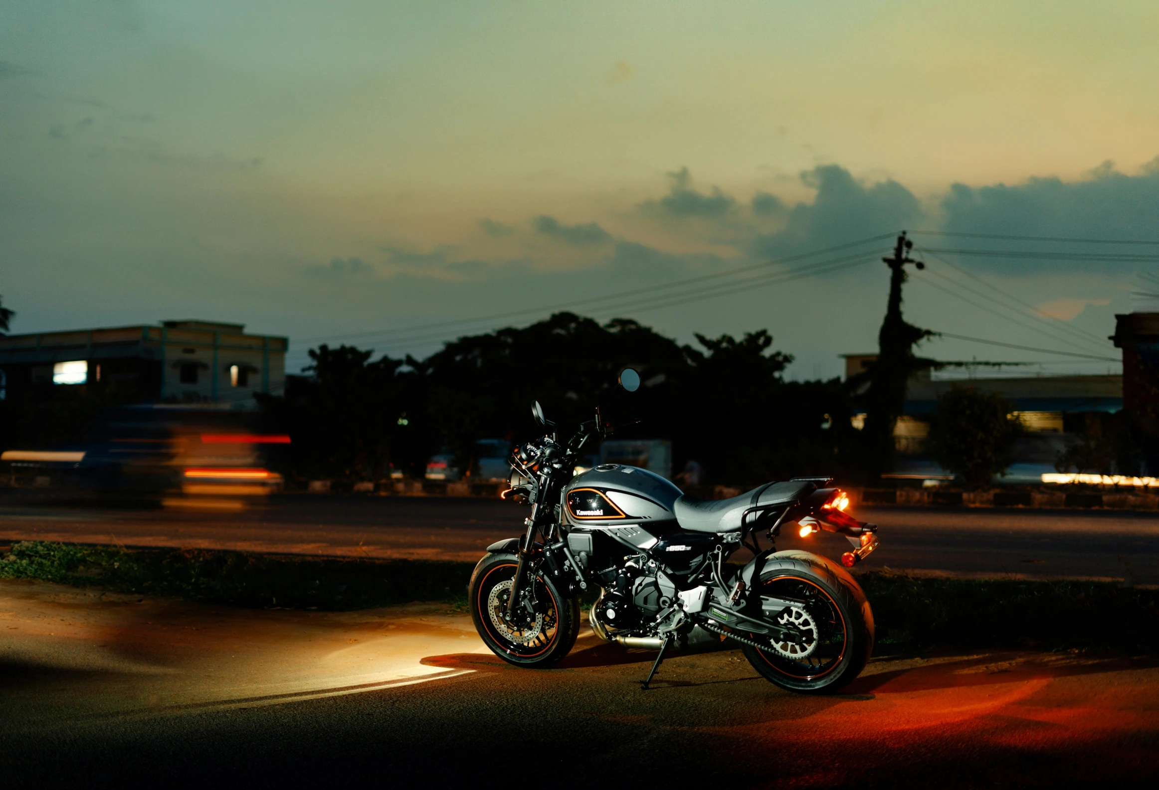 a motorcycle parked near the street at night