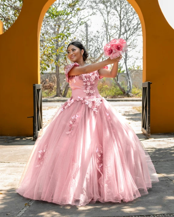 the woman is posing for the camera wearing a dress made of tulle