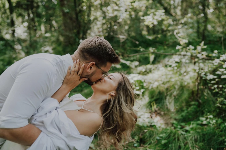 a man and woman kissing on the cheek