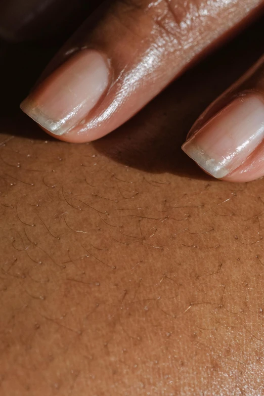 a female hand that is holding on to a manicure