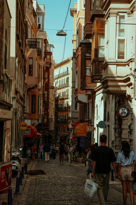 people walking along an empty and crowded street