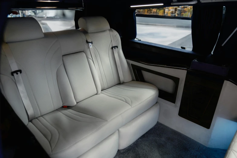 a car with white seats and floor boards is seen through a mirror