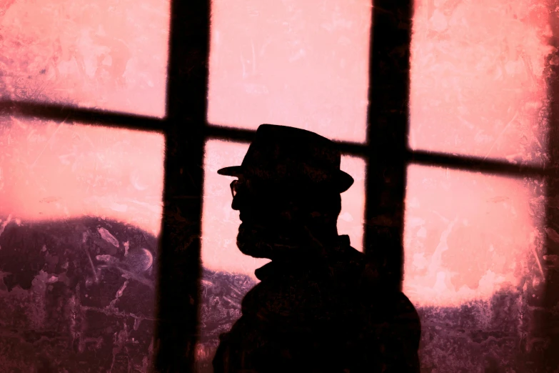 a silhouette of a man with a hat