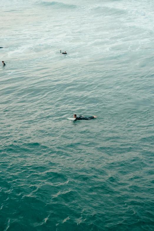 a person floating on top of a surfboard in the water