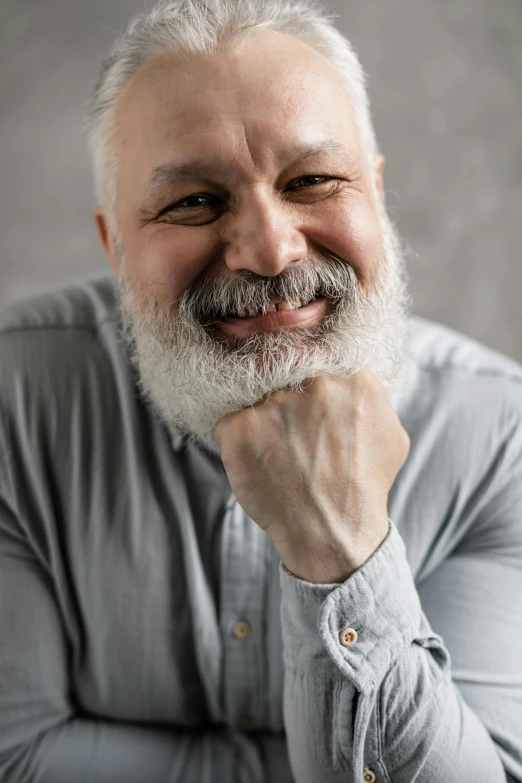 a man with a grey beard and a long mustache is staring at the camera
