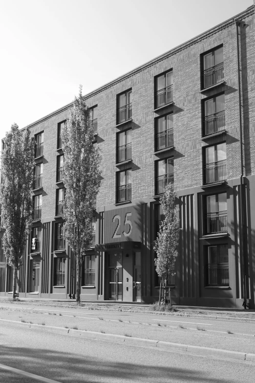 the apartment building is set back from the street and empty