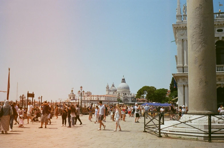 a crowd of people walking in front of an ornate building