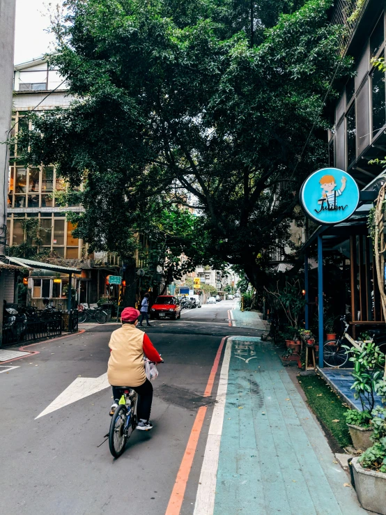 a person on a bicycle is near a tall building