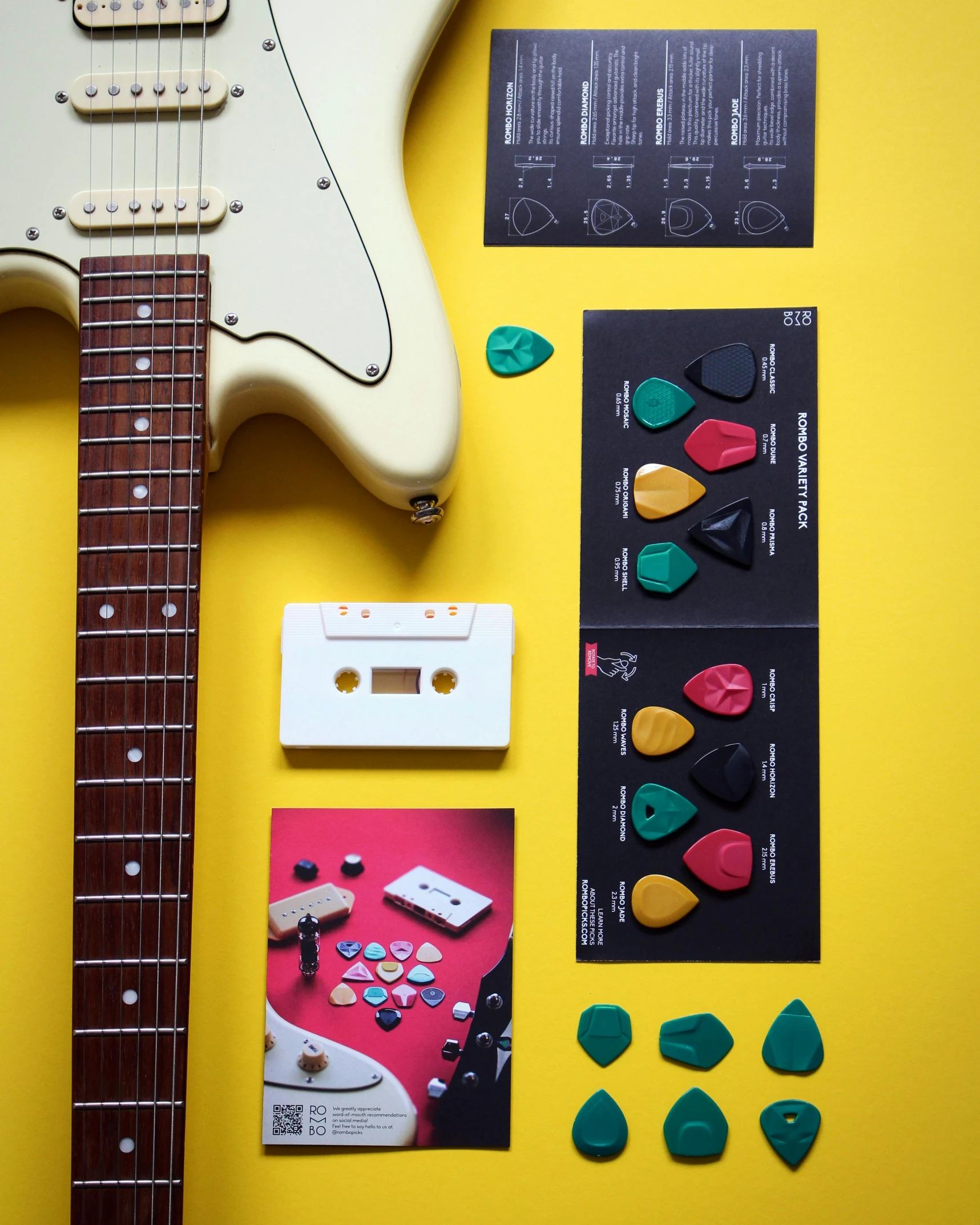 an electric guitar and other musical equipment sit on a yellow surface