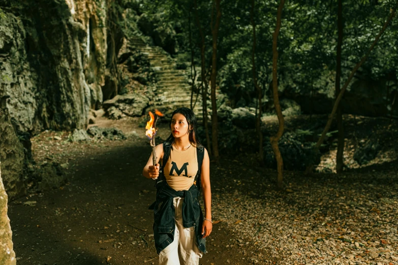 a woman with a small fire stick standing by herself