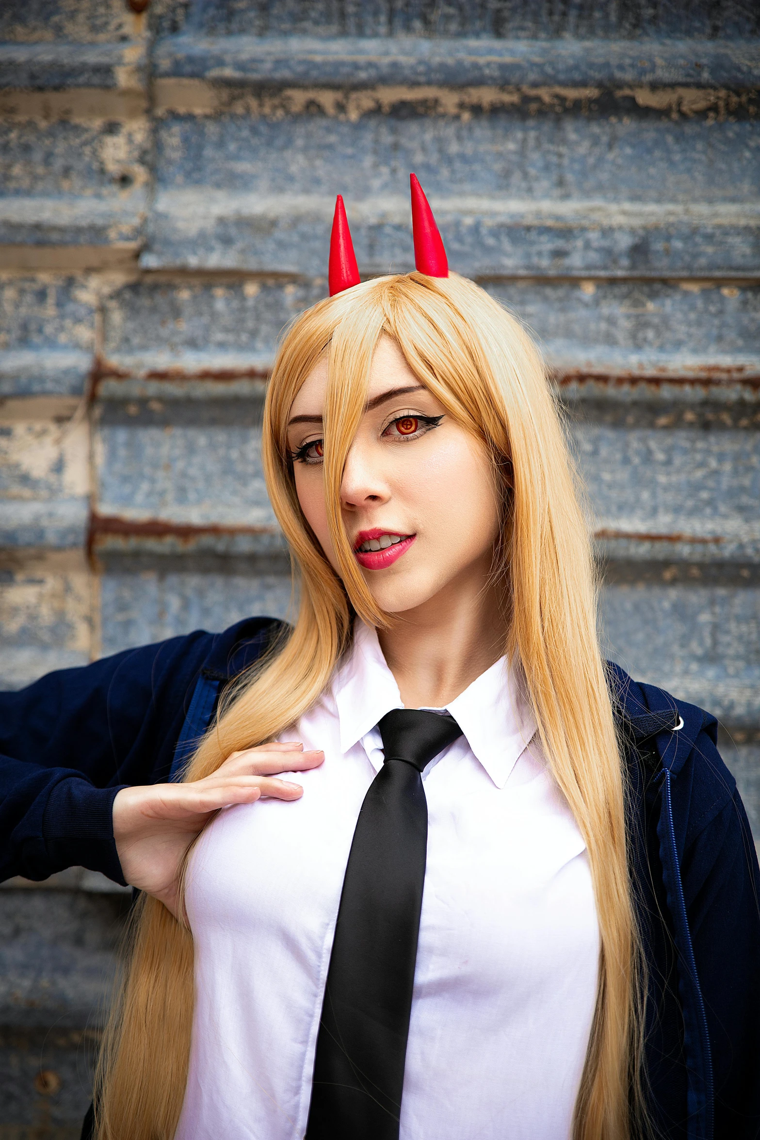 a woman with horns on her head, wearing a tie