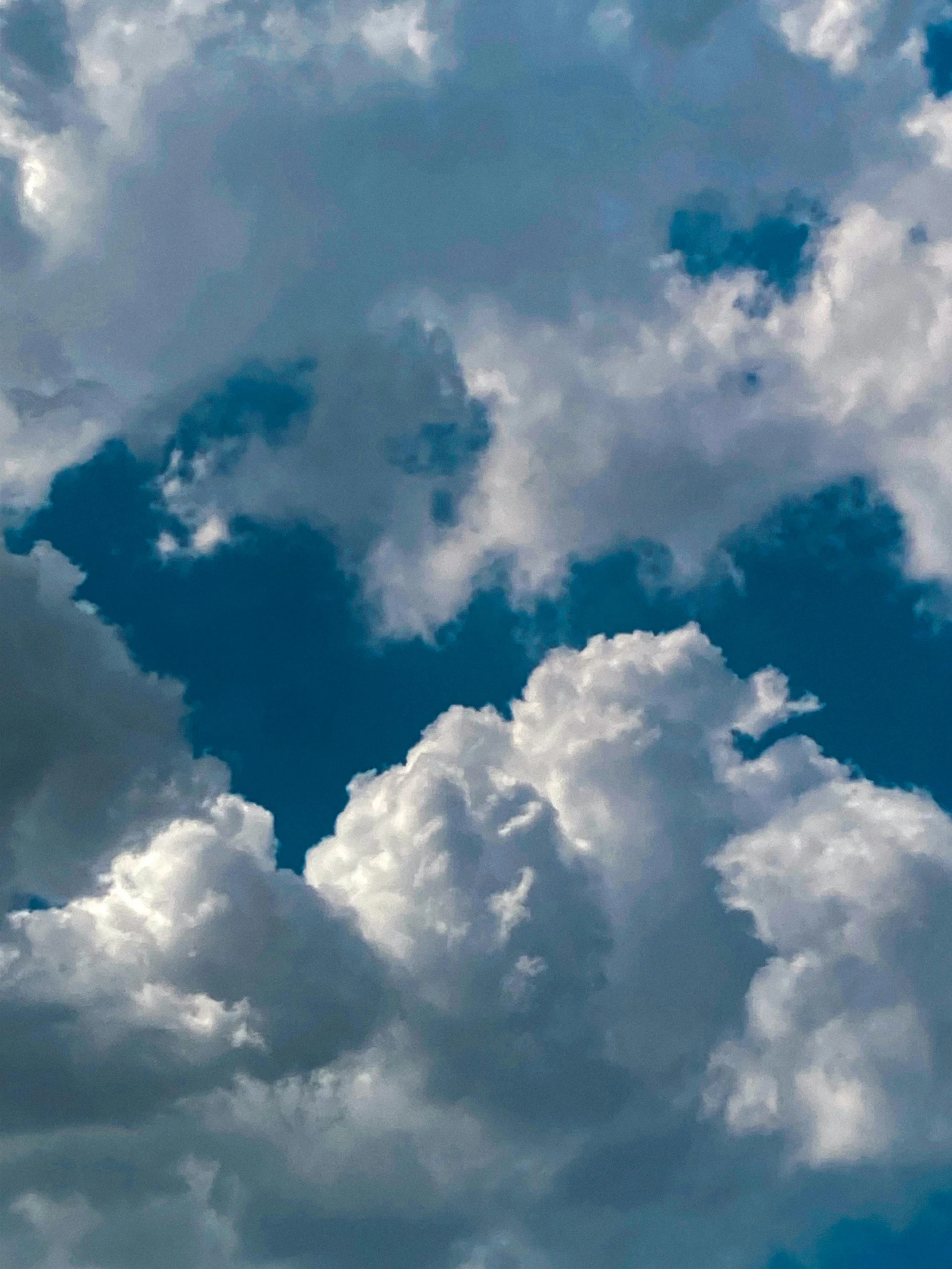 a jet flying in the sky with a lot of white clouds