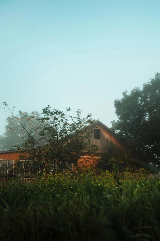 an old barn that has a tall wooden roof