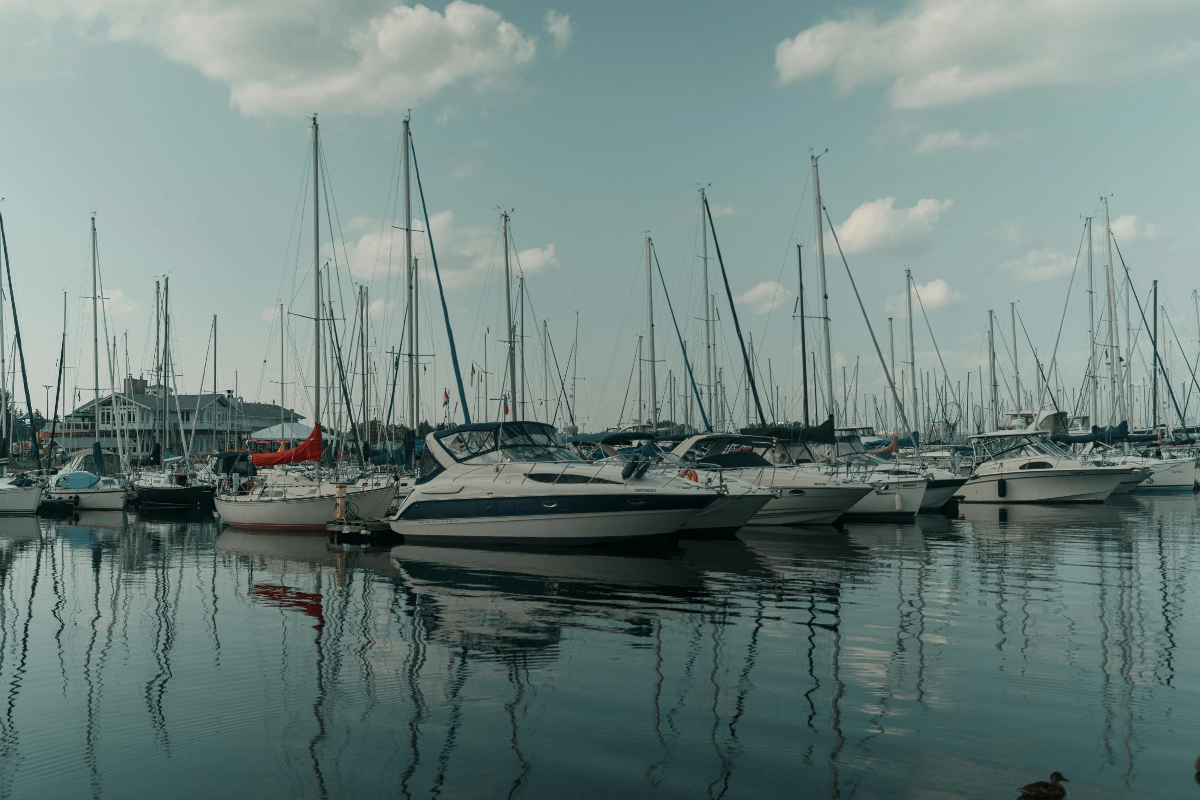 a harbor filled with lots of boats on a cloudy day