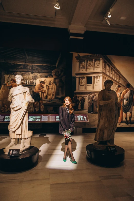 a woman posing in front of a display in a museum