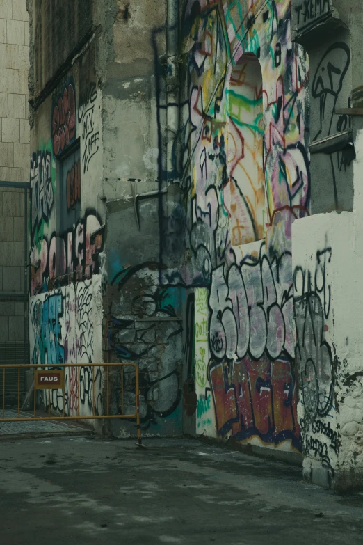 a man riding a skateboard past lots of graffiti