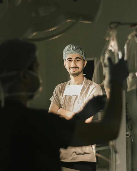 a male in an operating room wearing an on / off scrub