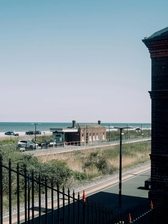 a large field on the beach behind a fence