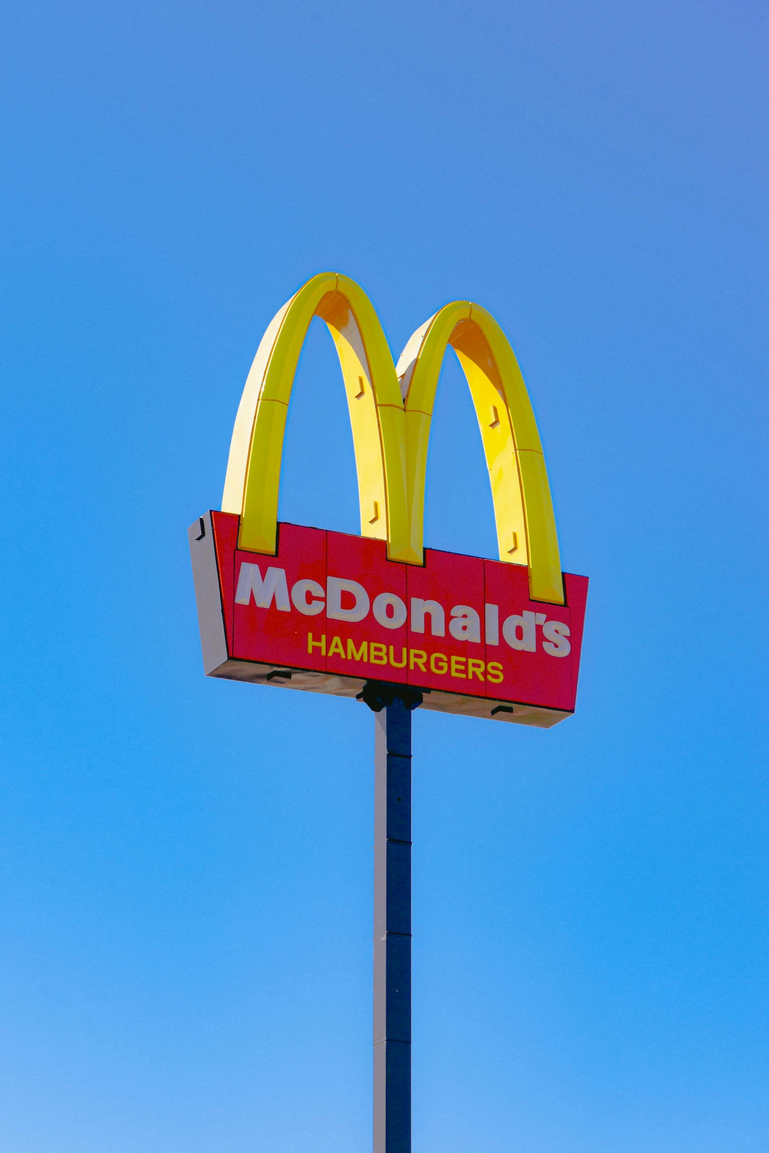 a large mcdonald's sign on top of a pole