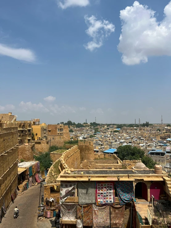 people standing outside and walking around in front of small buildings