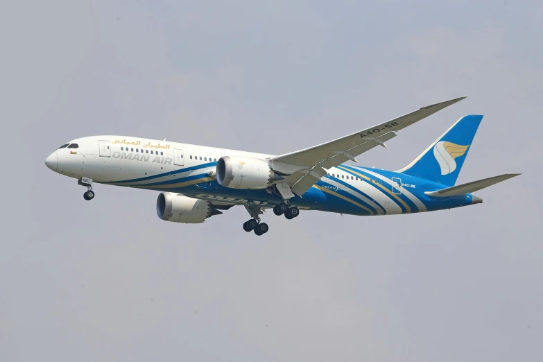 a blue and white commercial airliner in flight