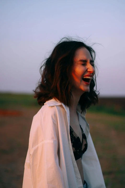 a woman with very long dark hair laughing