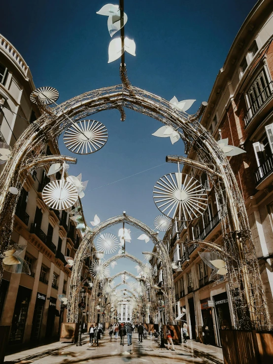 an arch covered with lights in a town square