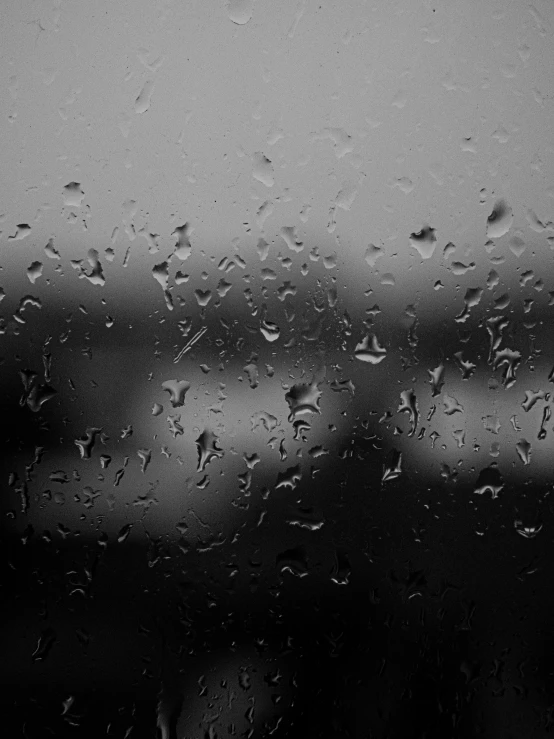 drops of rain on the windshield of a car