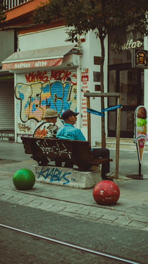 an old man on a bench in the middle of the street