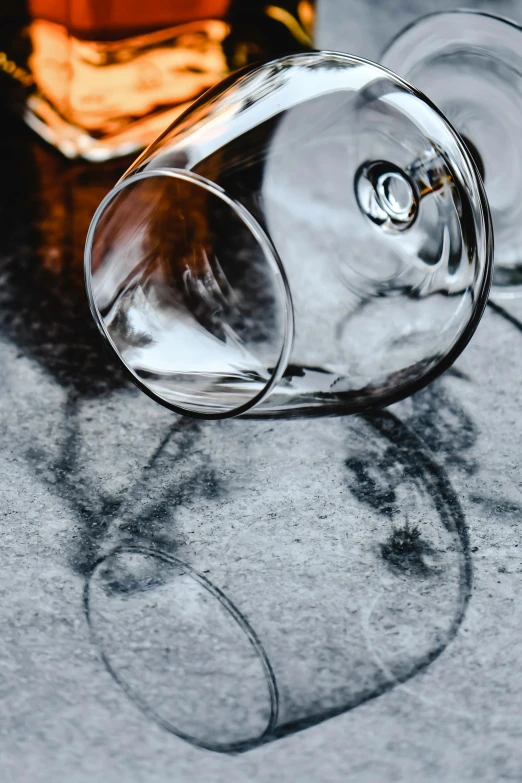 a glass sitting on a table next to a bottle