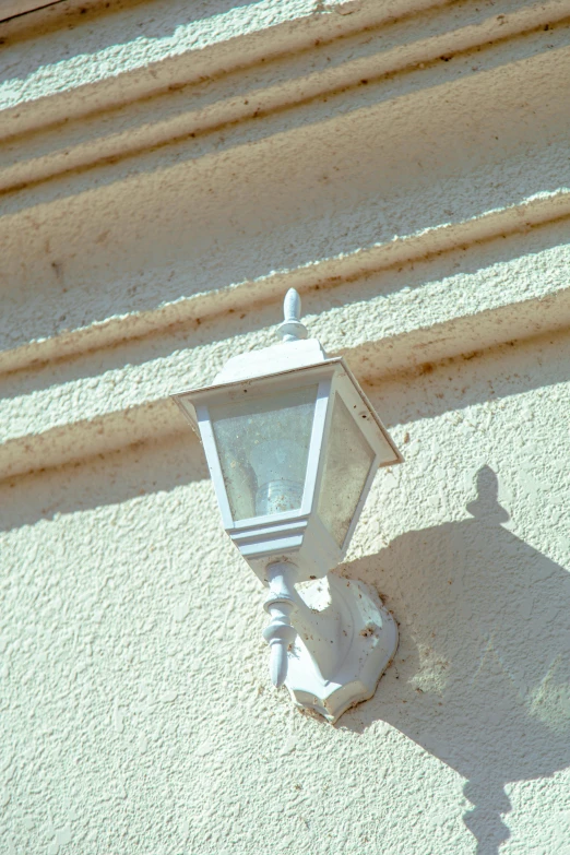 an old street light has a shadow of the street