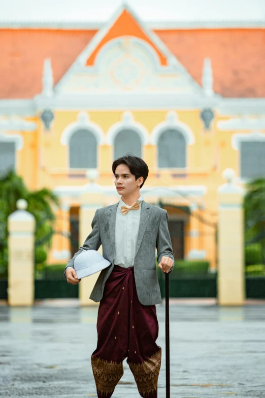 a boy standing on a wet parking lot