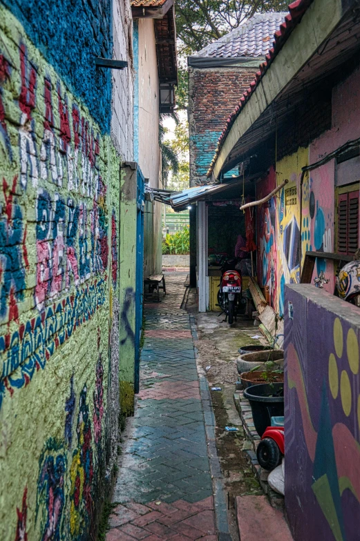 the narrow alley features brightly painted wall