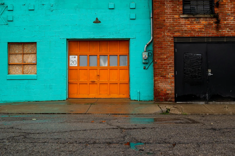 there is a door to some blue buildings and a yellow door