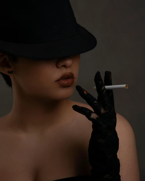 a woman holding a cigarette in her right hand