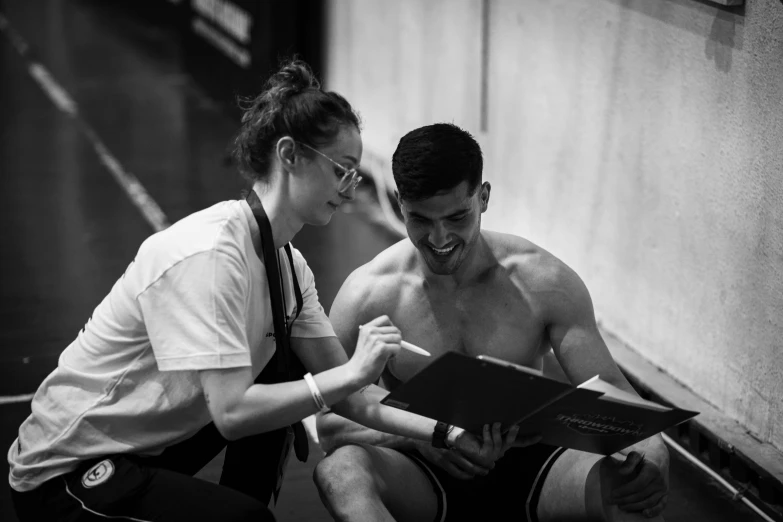 man and woman standing in an indoor area looking at soing