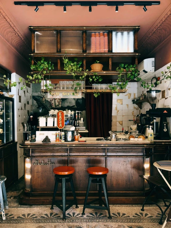 an antique looking kitchen with red stools