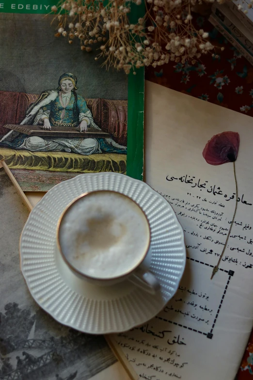 cappuccino and old book lying on old paper