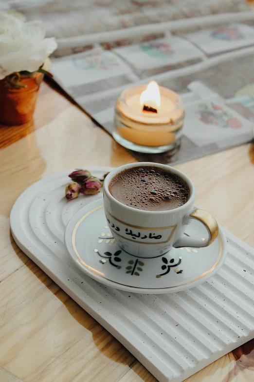 a table with a small cup of  chocolate