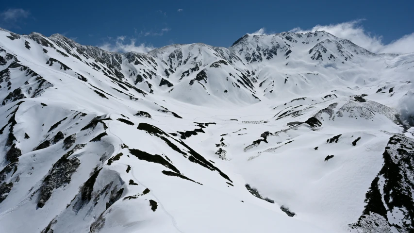 the snow is very thick and tall as it appears to be on top of a mountain